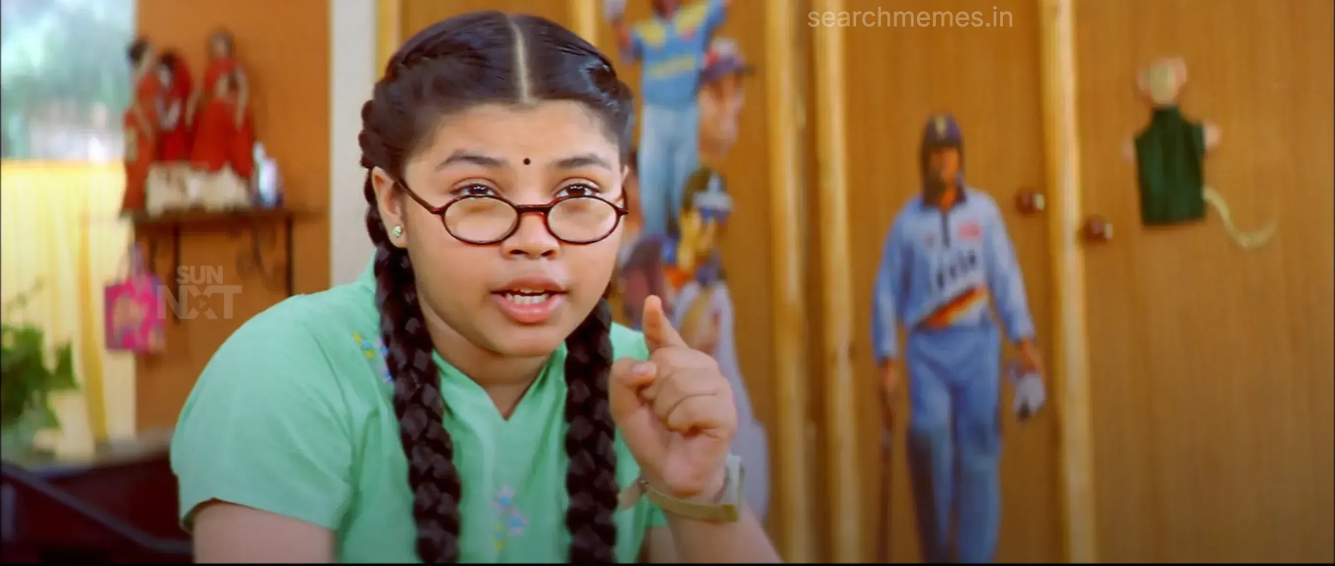 Schoolgirl with braided hair and glasses pointing her finger forward in Ghilli