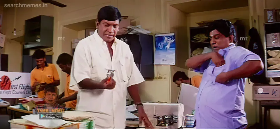 Vadivelu holding small object looking sternly as Singamuthu clutches shirt pocket