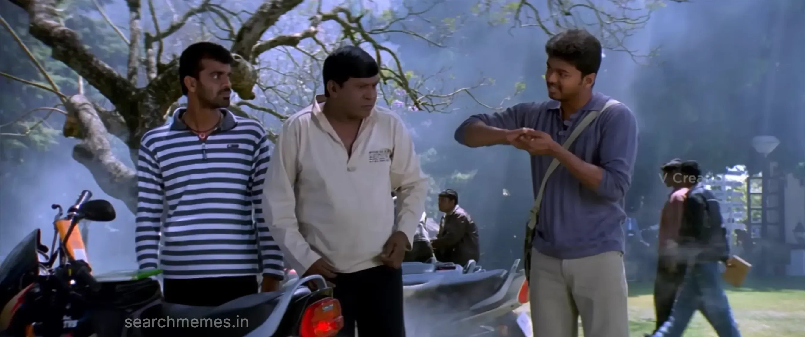 Vadivelu smiling proudly and flexing while talking to Vijay on campus