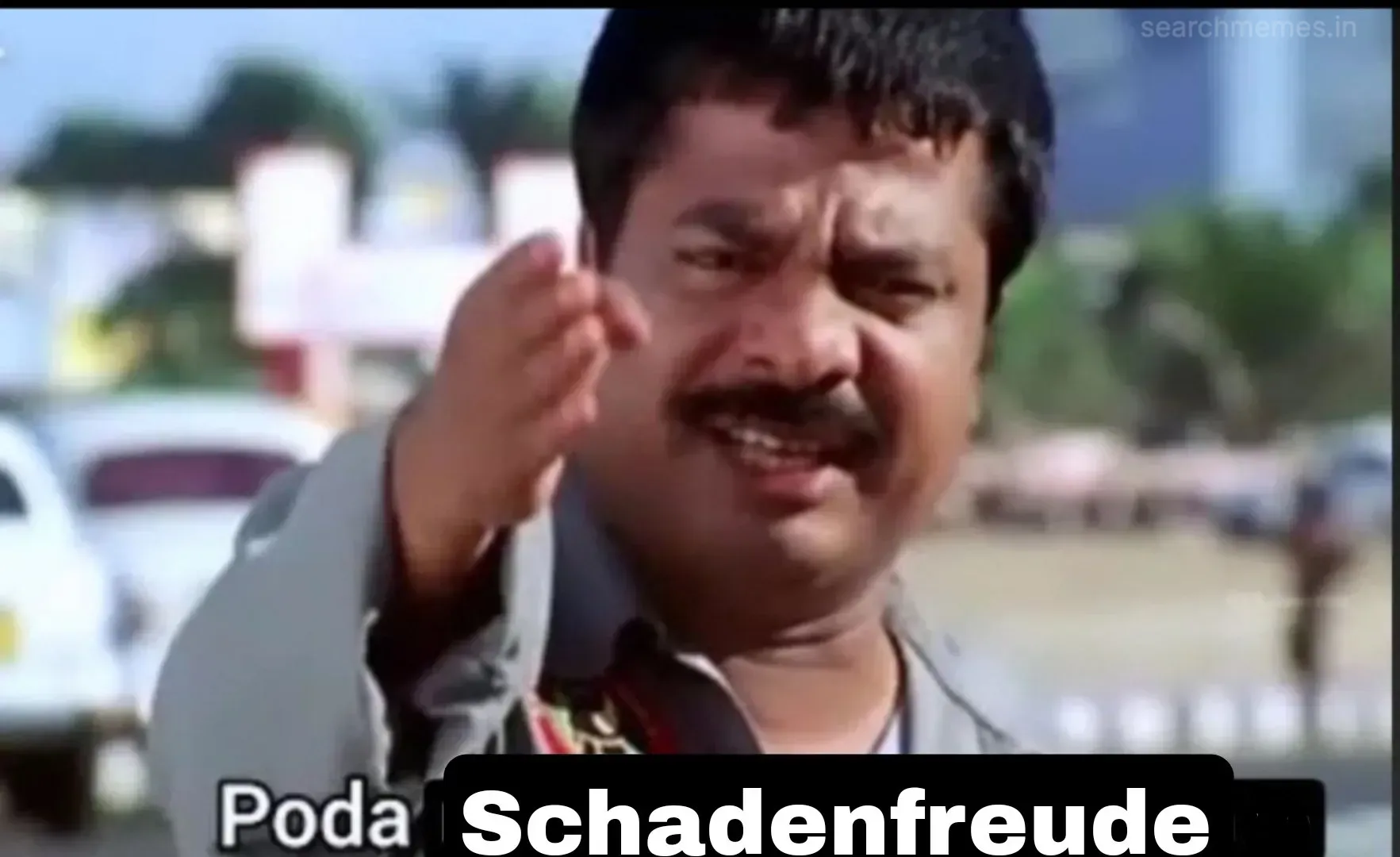 Pandiarajan waving his hand angrily with a furious face outdoors