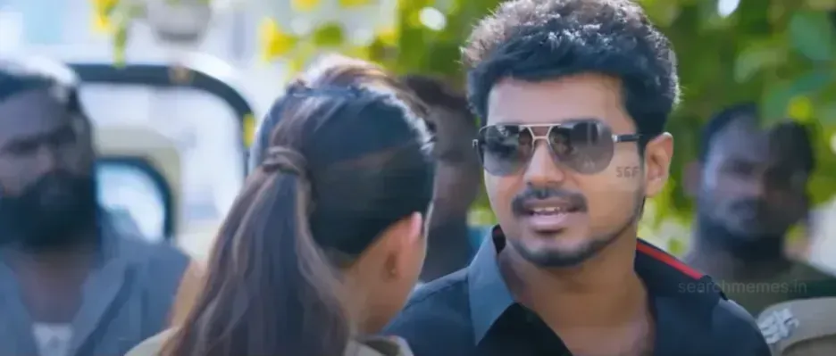 Vijay in black shirt and sunglasses talking mockingly to a female police officer