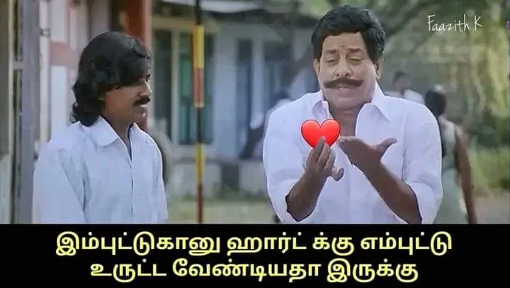 Singamuthu blowing a kiss while holding a heart graphic in his hand