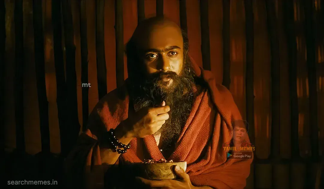 Suriya dressed as Bodhidharma pausing solemnly while holding a wooden food bowl