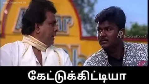Charlie and Singamuthu in traditional attire pointing with questioning expressions