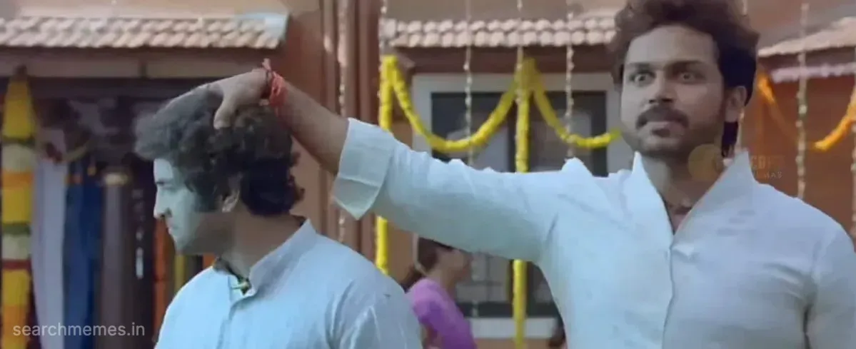 Santhanam grabbing Karthi's shoulder urging him to look at the gold items