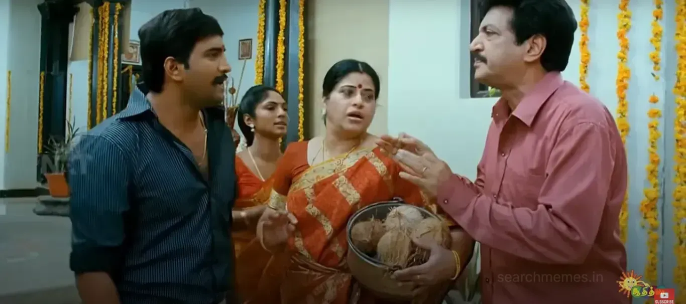 Santhanam holding a pot of coconuts and arguing with Nizhalgal Ravi in a traditional house