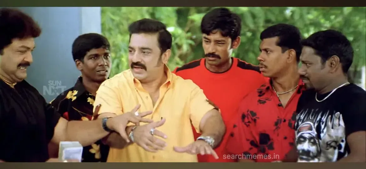Kamal Haasan looking sheepish and smiling apologetically beside Prabhu