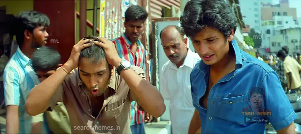 Santhanam holding his cheeks screaming in comic horror as a phone is smashed