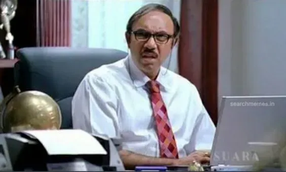 Sathyaraj as Virus looking down with stern authoritarian glasses