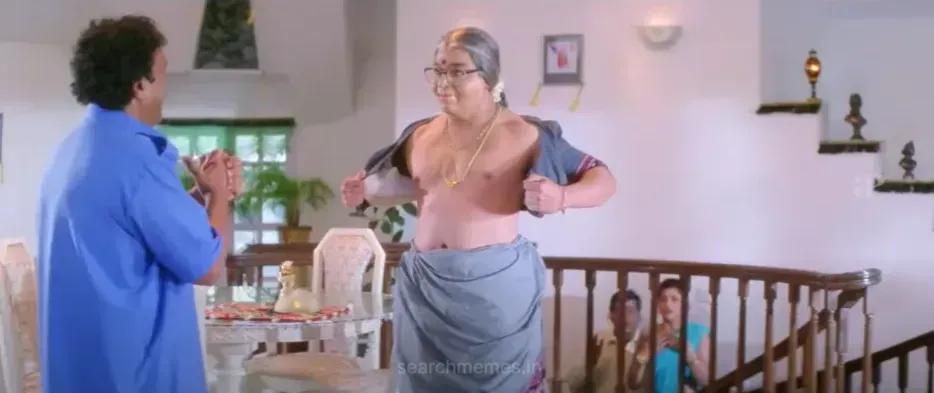 Kamal Haasan dressed as an elderly woman revealing chest to Nassar