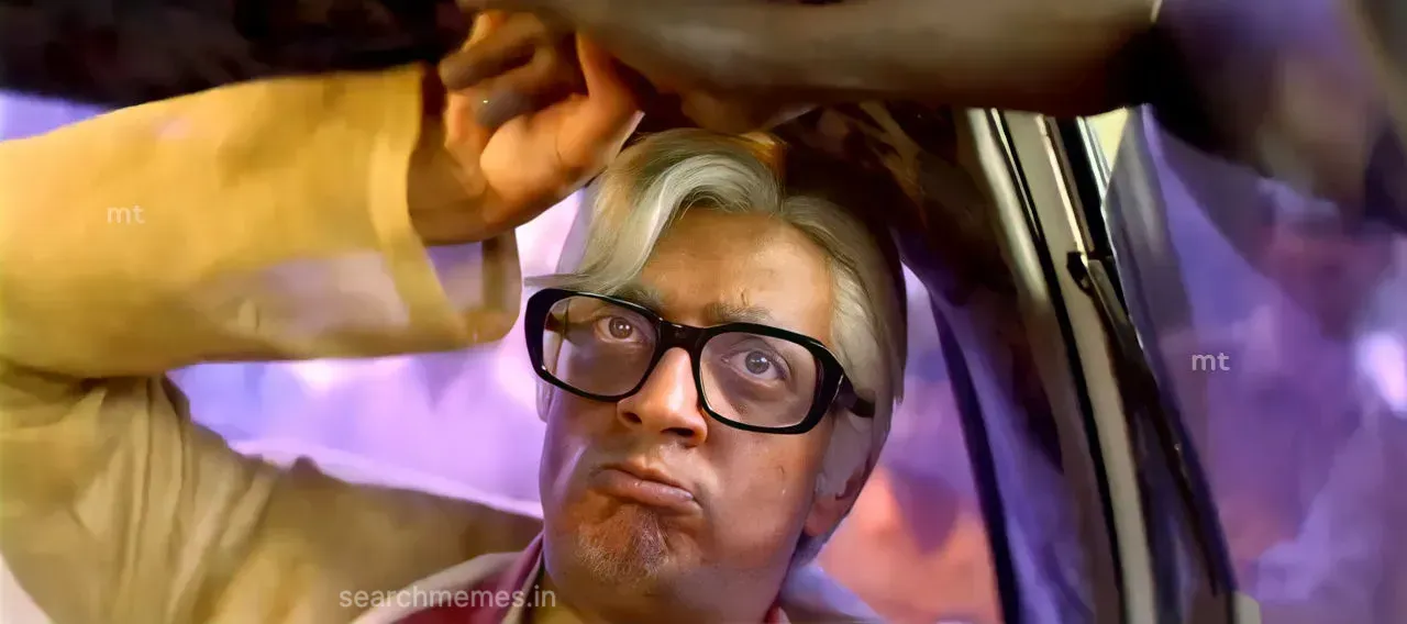 Raghuvaran sitting in formal attire clenching his fist with simmering vengeful eyes
