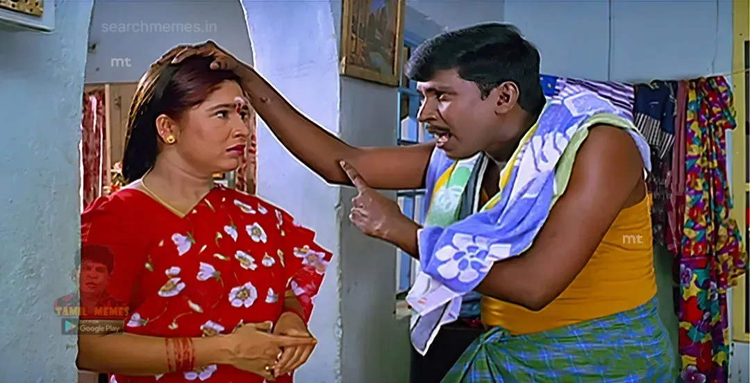 Vadivelu holding Kovai Sarala's head and pointing his finger angrily