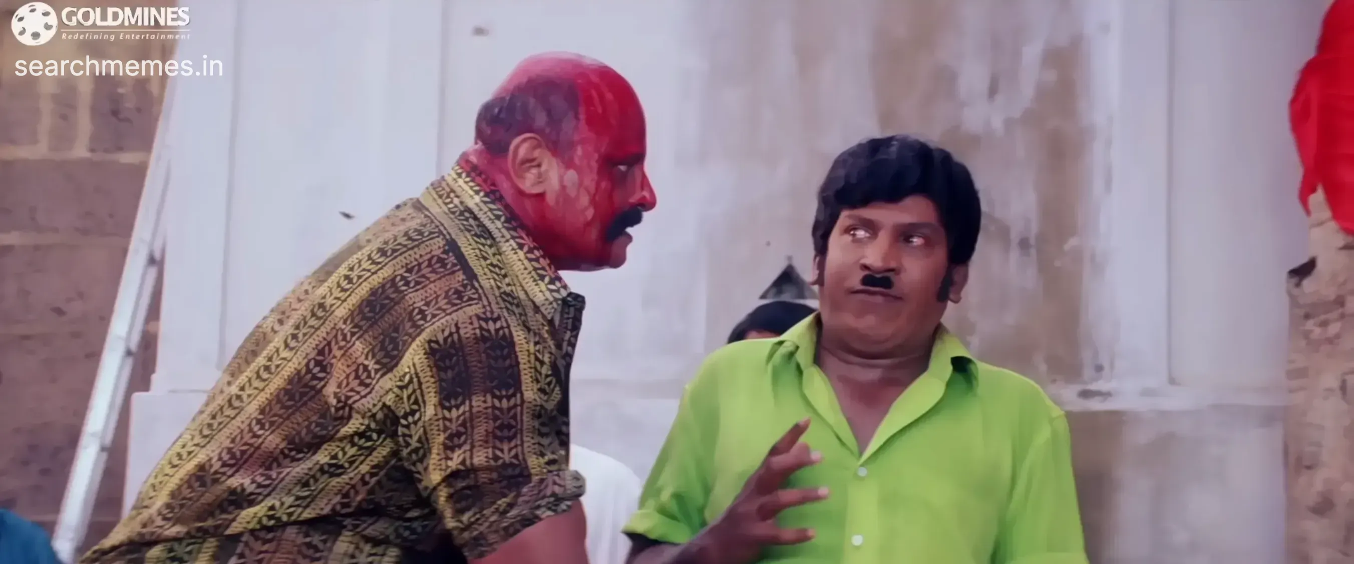 Vadivelu gesturing with his hands toward an injured red-faced man