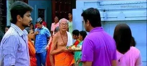 Santhanam staring in shock at Udhayanidhi with a reprimanding look