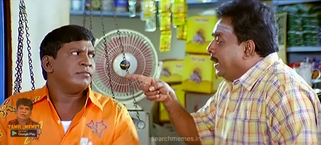 Singamuthu pointing his finger toward a puzzled Vadivelu in a grocery shop in Aanai