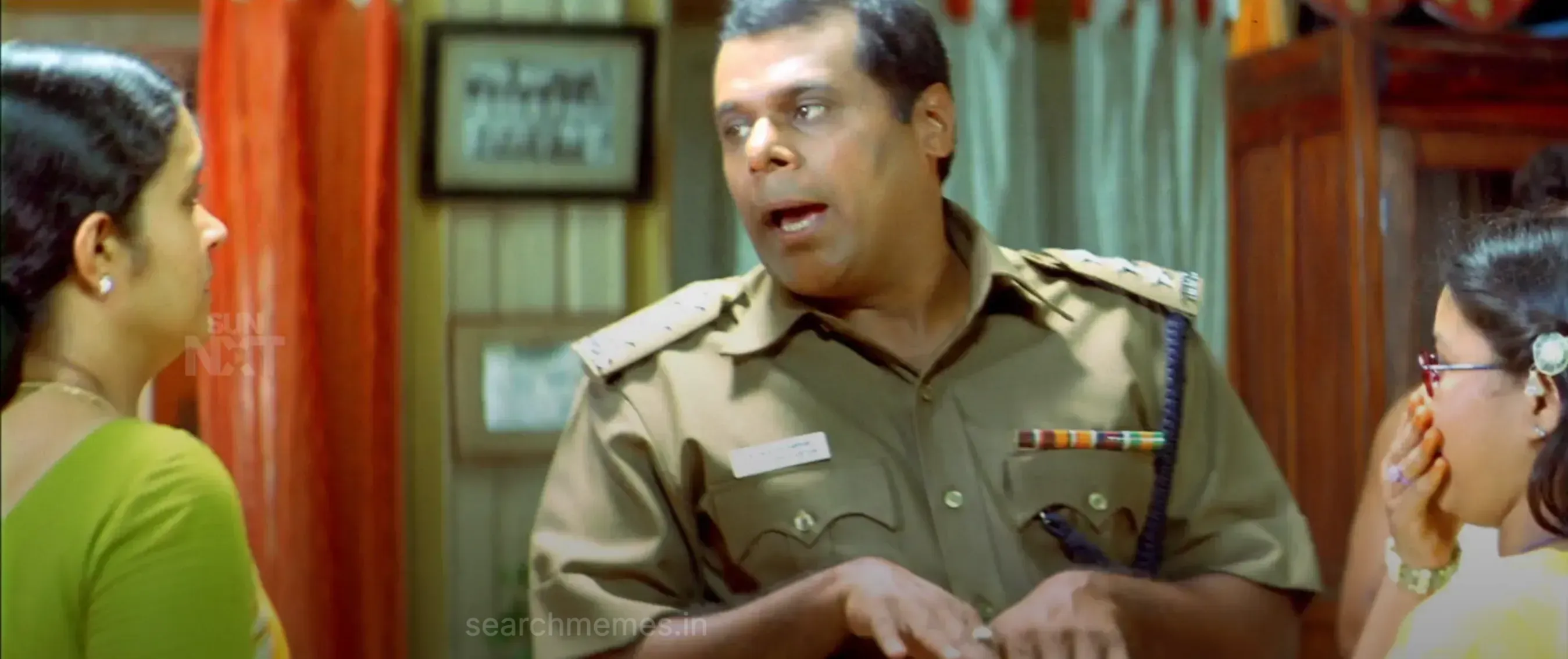 Vijay grinning playfully beside a stern-faced Ashish Vidyarthi indoors