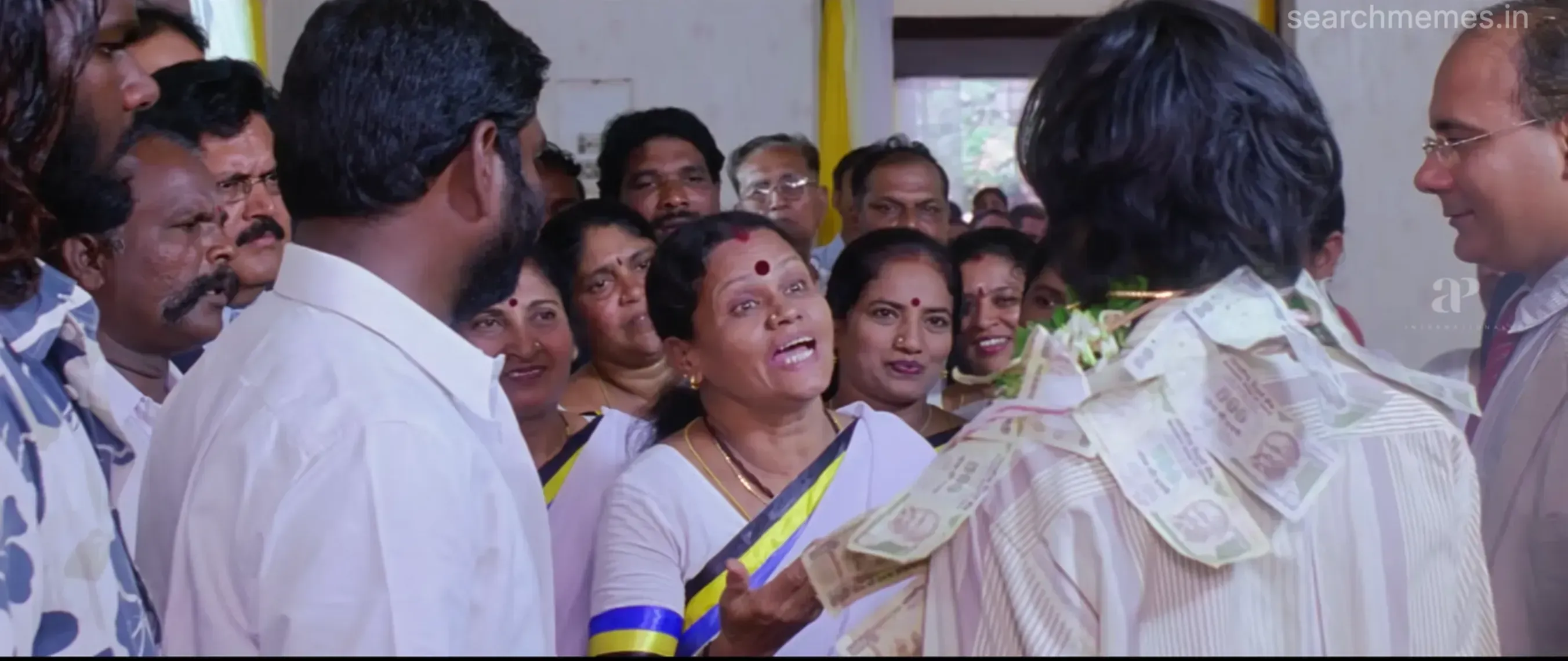 Dhanush examining a baby with admiration and predicting political leadership