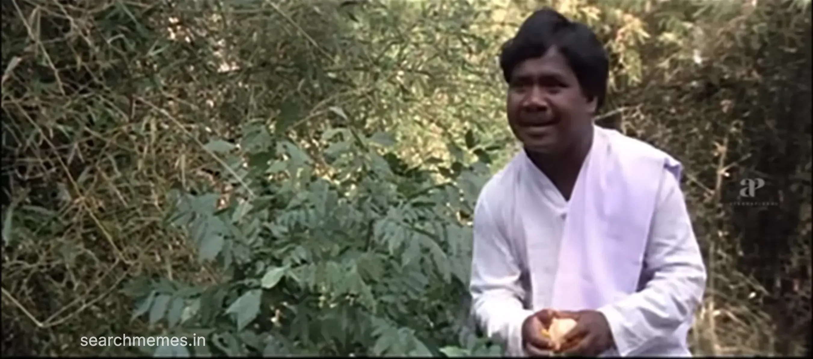 Goundamani standing with both hands held up busy demanding someone feed him