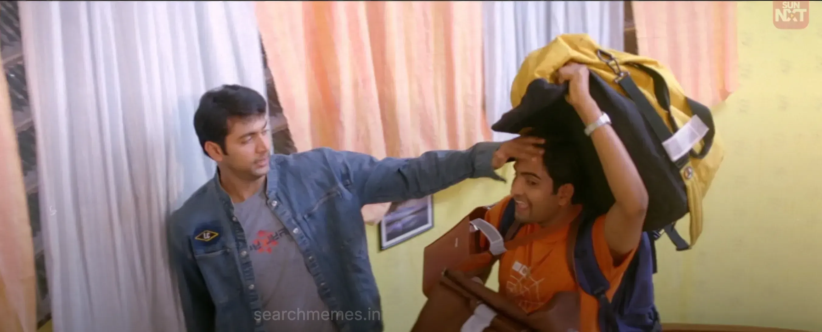 Jayam Ravi smiling sarcastically at Santhanam who looks pleased