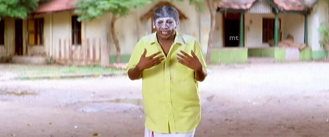 Vadivelu staring blankly in shock with ash smeared across his forehead