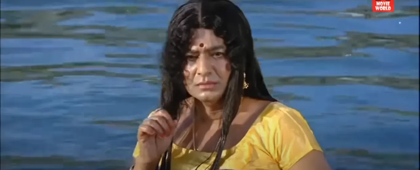 Vivek dressed as a woman standing in water with a suspicious look in Padikkathavan