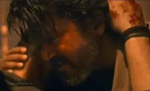 Vijay with messy hair and emotional look hugging someone tightly in Leo
