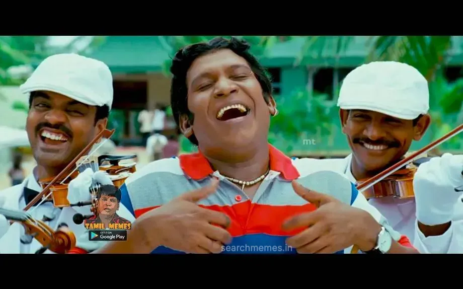 Vadivelu with a weeping expression surrounded by violin musicians playing