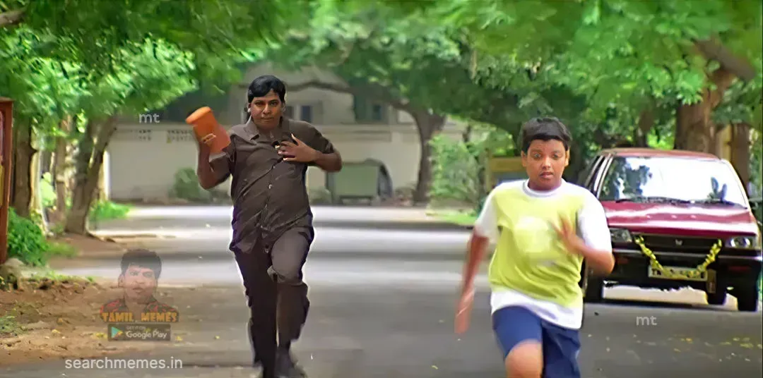 Vadivelu clutching a red building brick looking ahead with angry determination