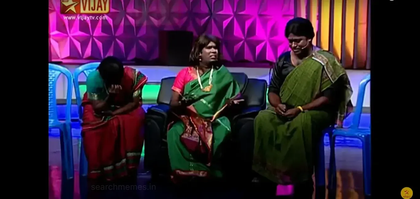 Ramar dressed in a green saree gesturing with open palms in bewilderment