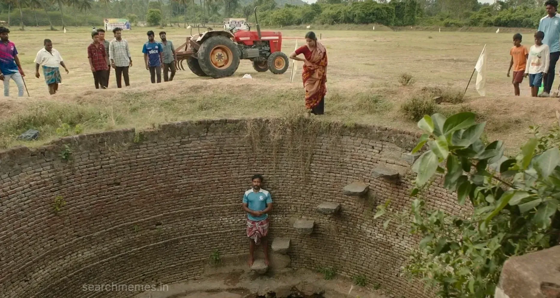 Gethu Dinesh crouched down low inside an empty stone well looking upward
