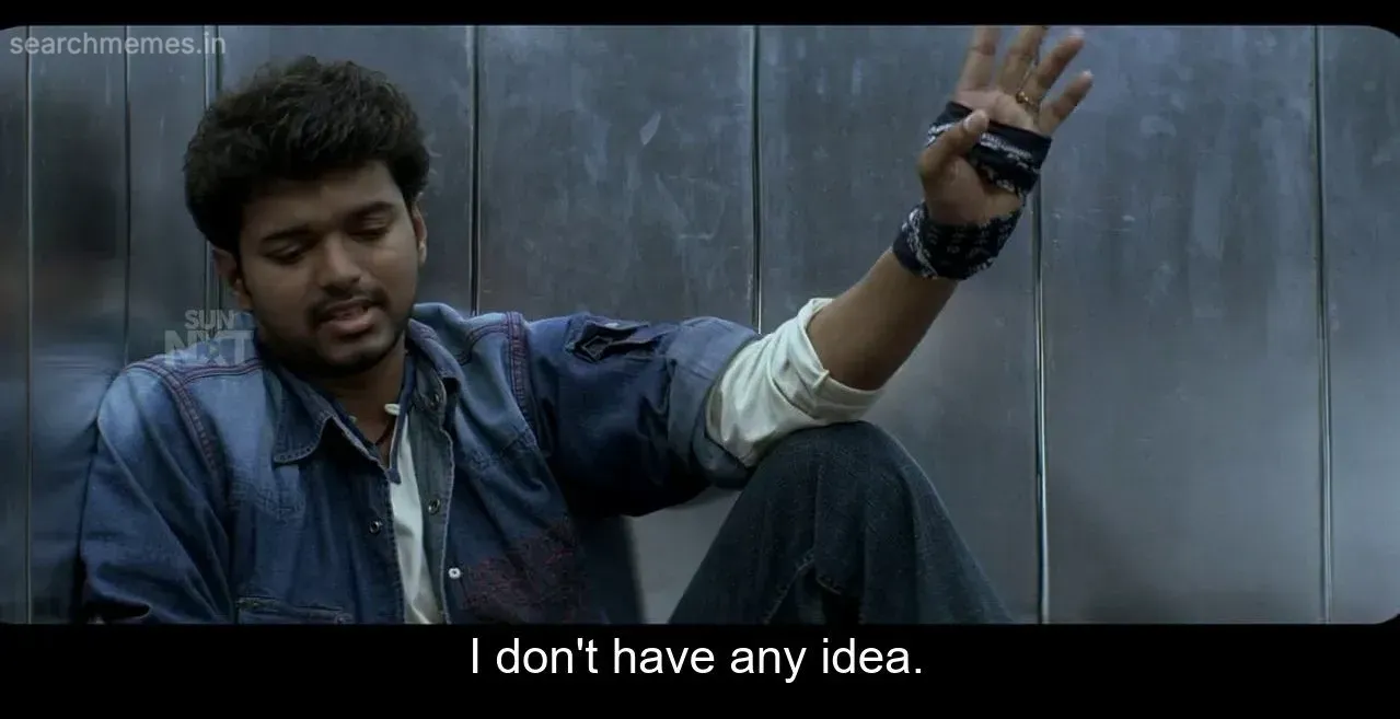 Vijay sitting on an elevator floor, looking frustrated and gesturing 'I don't have any idea' from Pokkiri.