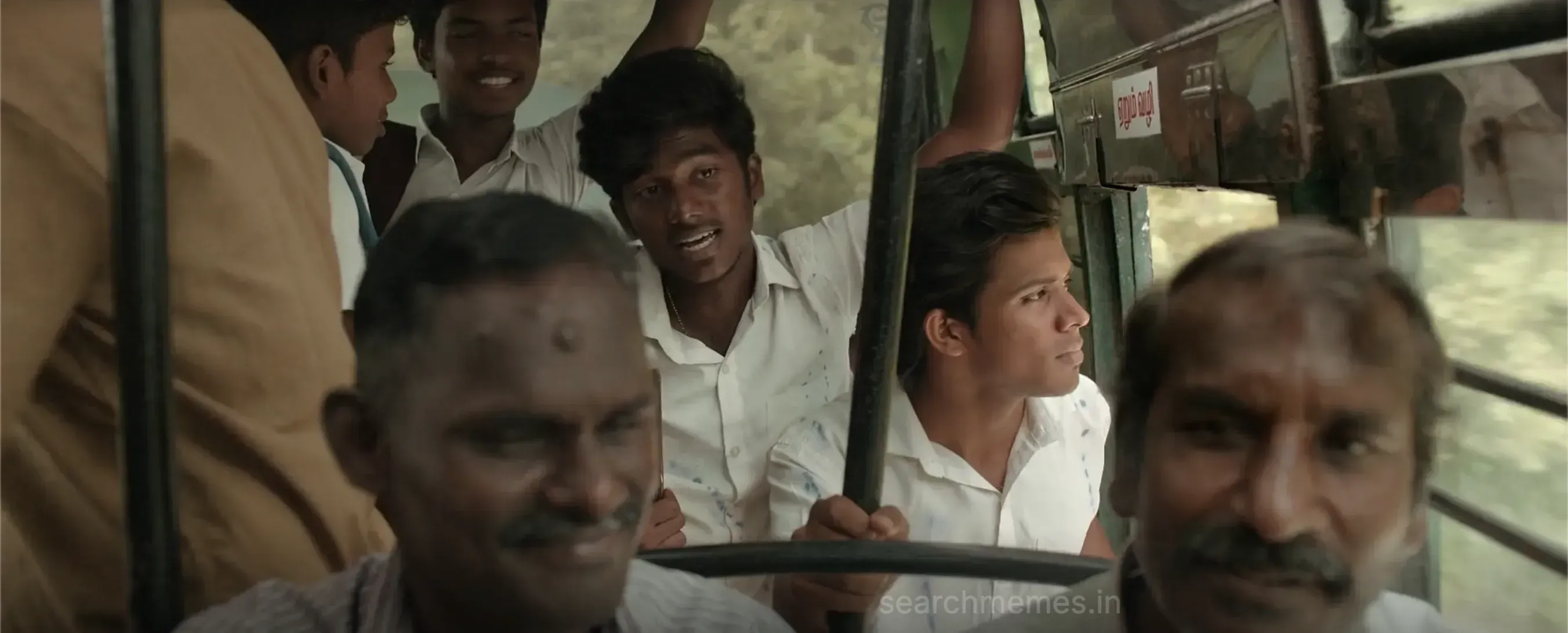 A man seated in a bus speaking emphatically during a lively soundtrack conversation