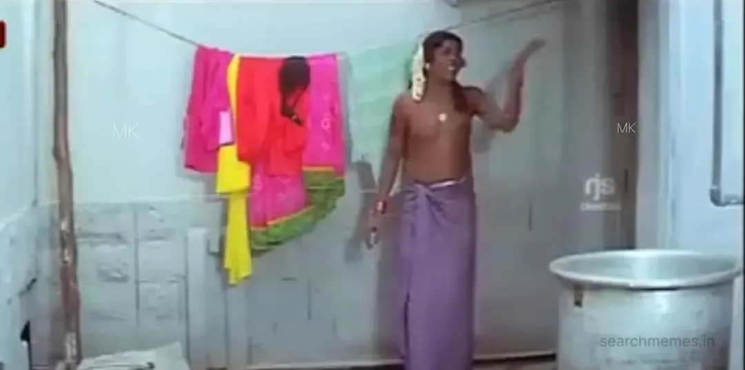Vadivelu wearing a purple towel around his waist gesturing and shouting out loud
