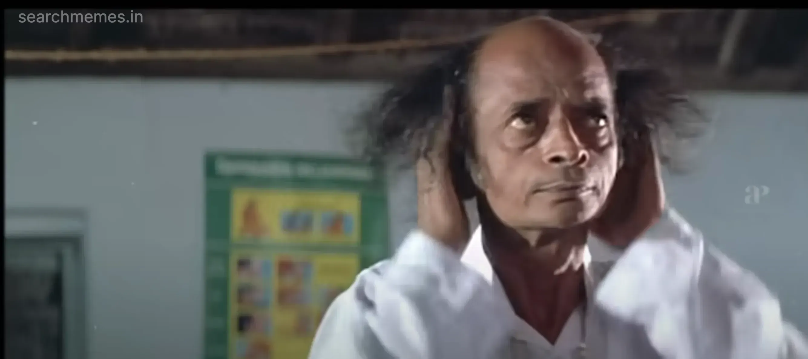 Goundamani pulling his hair, looking shocked and exasperated.