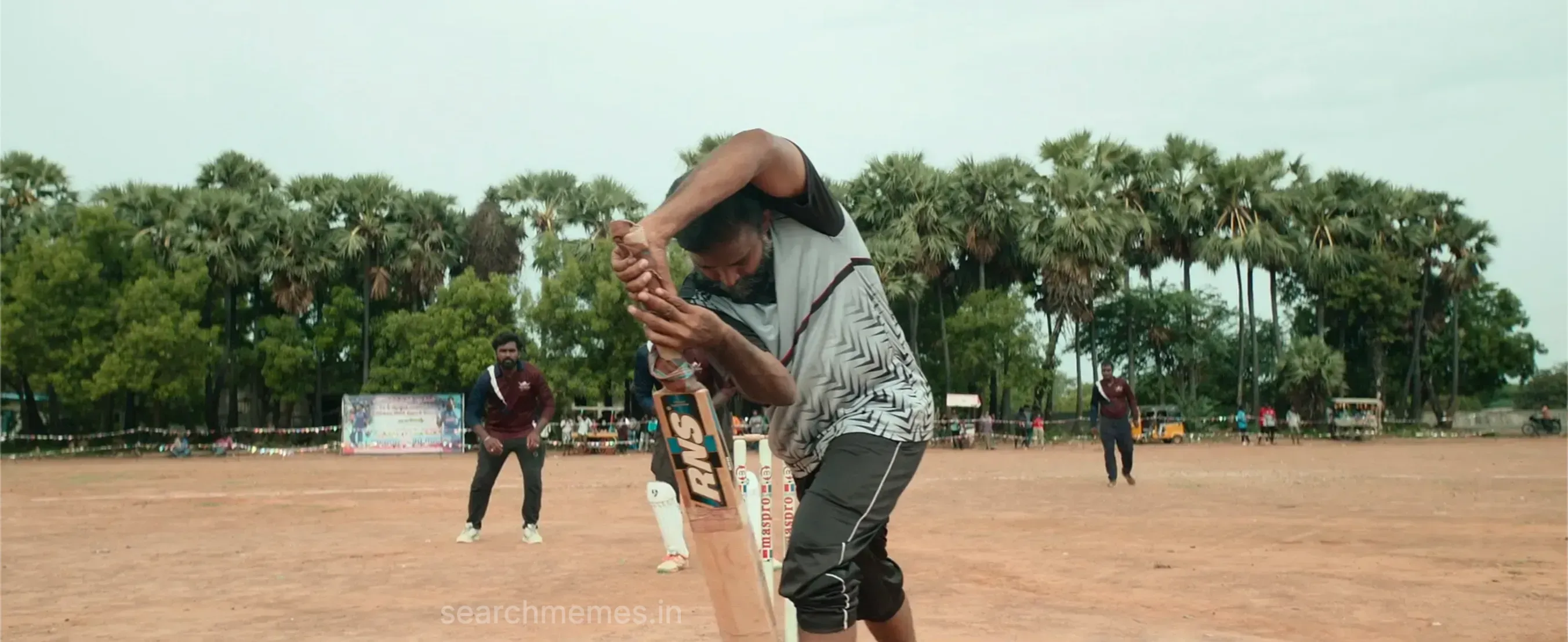 Gethu Dinesh defending a delivery with his cricket bat on a village ground