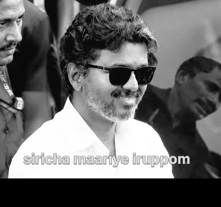 Vijay wearing dark sunglasses and a subtle smile surrounded by people in black and white