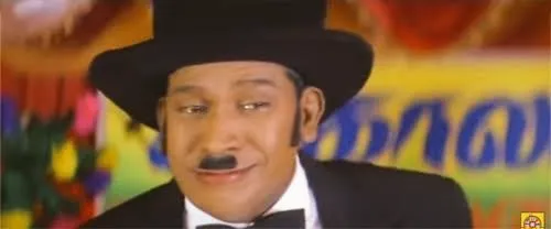 Vadivelu clenching teeth and shivering in absolute dread during a magic trick