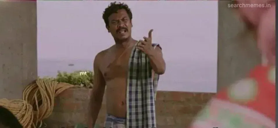 Samuthirakani speaking softly with open hands to Andrea in a hallway