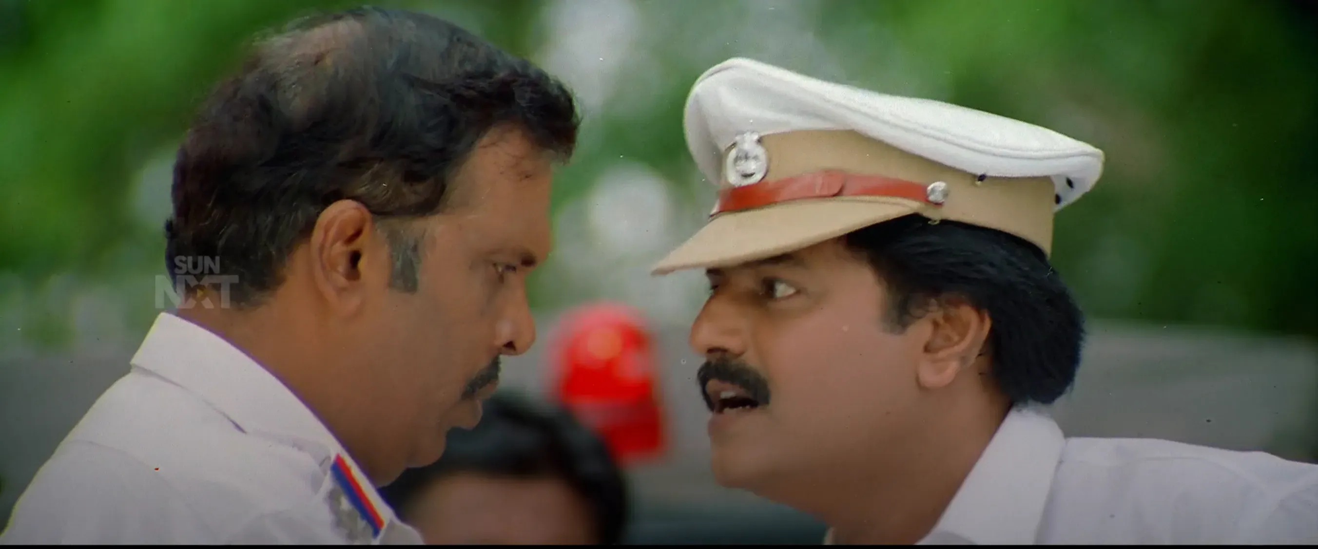 Vivek in a traffic police uniform talking face-to-face with another officer