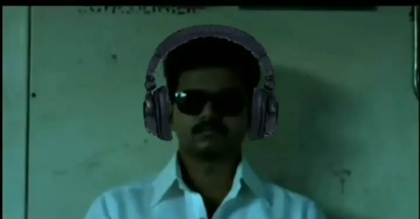 Vijay wearing black sunglasses and headphones looking straight ahead