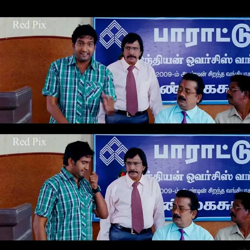 Santhanam in a plaid shirt speaking sarcastically from a bank stage