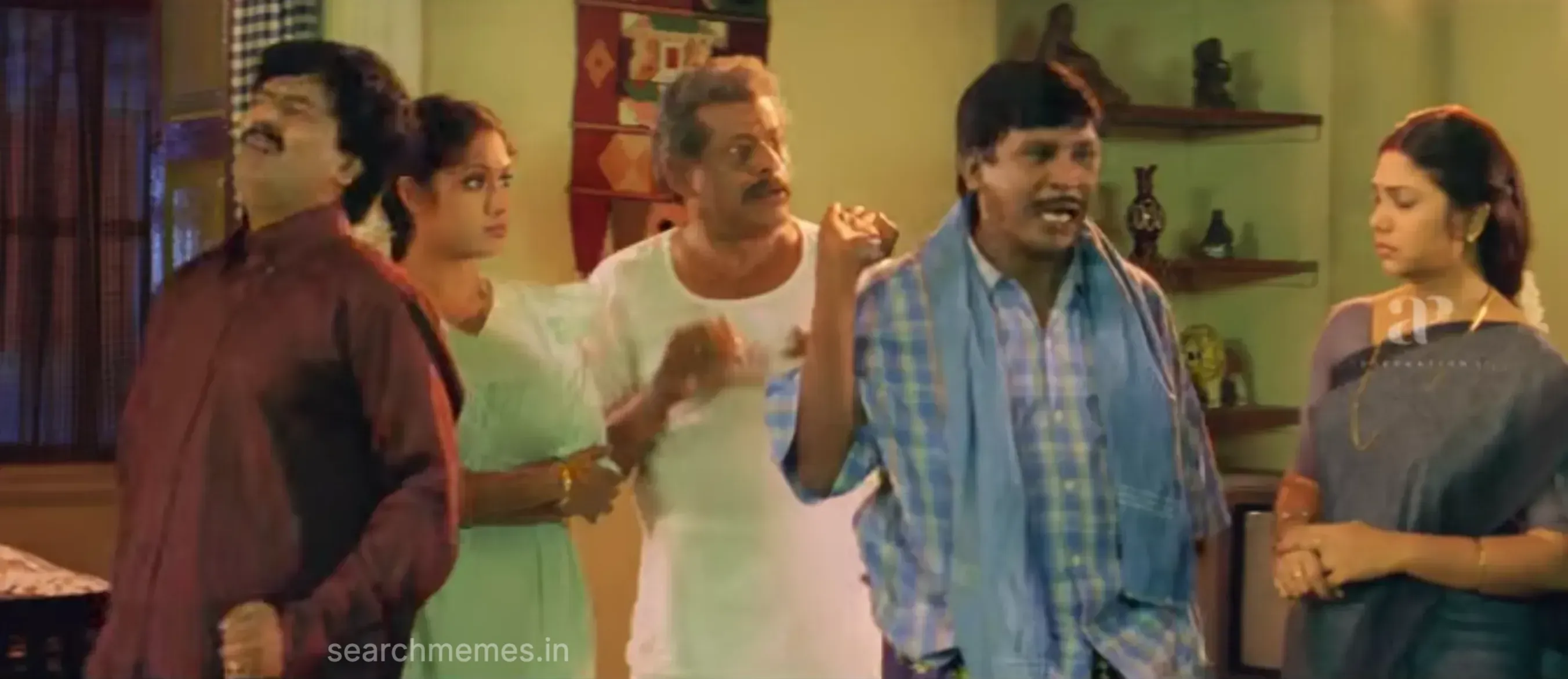 Vadivelu rolling his eyes in annoyance while listening to an elderly relative speak