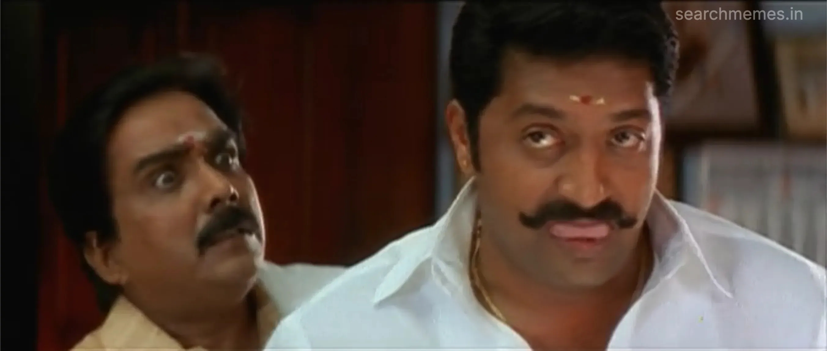 Prakash Raj with a mischievous smile and his tongue slightly out.