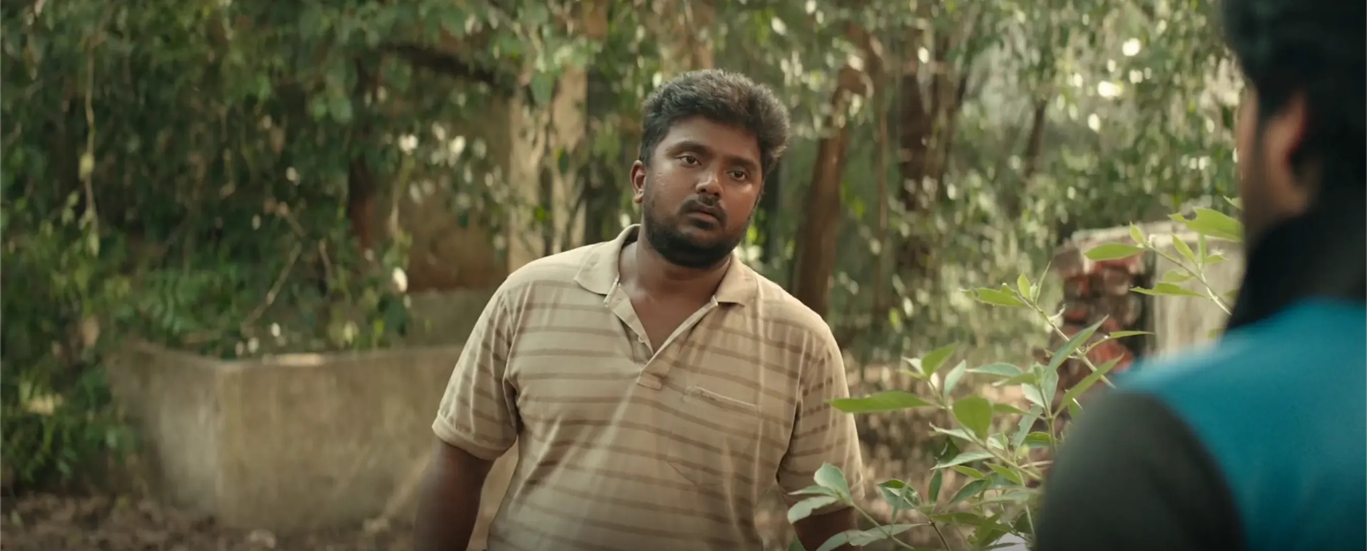 Saravanan looking thoughtful and slightly confused outdoors.