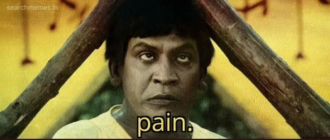 Vadivelu with a soot-stained face rolling his eyes up in distress with the word pain