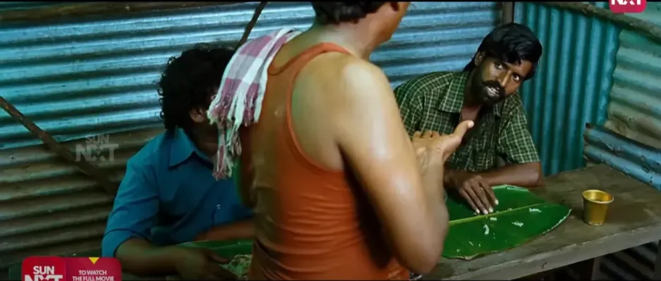 Soori sitting at a rustic mess table with a clean banana leaf waiting for food