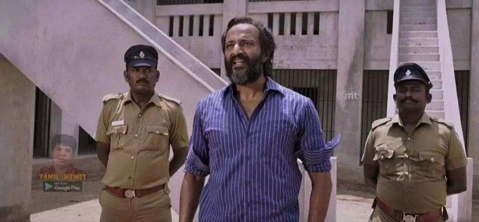 Kishore with folded hands speaking politely inside a prison courtyard