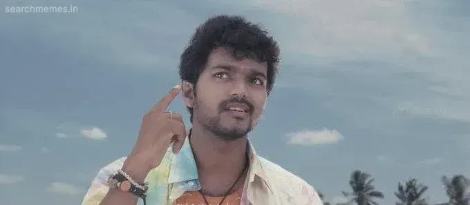 Vijay pointing a finger near his temple with a puzzled expression