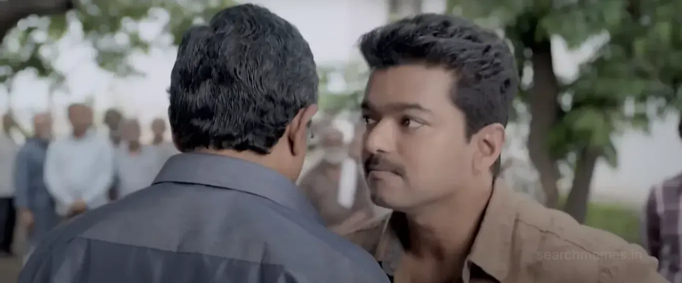 Vijay staring intensely into the eyes of a man standing right in front of him